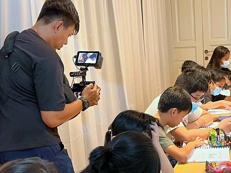 A videographer filming a math class.